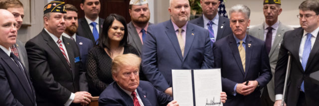 President Donald J. Trump displays his signature after signing an executive order for a National Roadmap to Empower Veterans and End a National Tragedy of Suicide