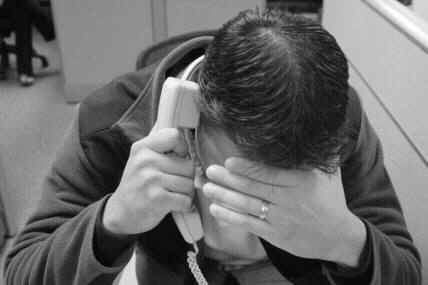 Man stressed on the phone.